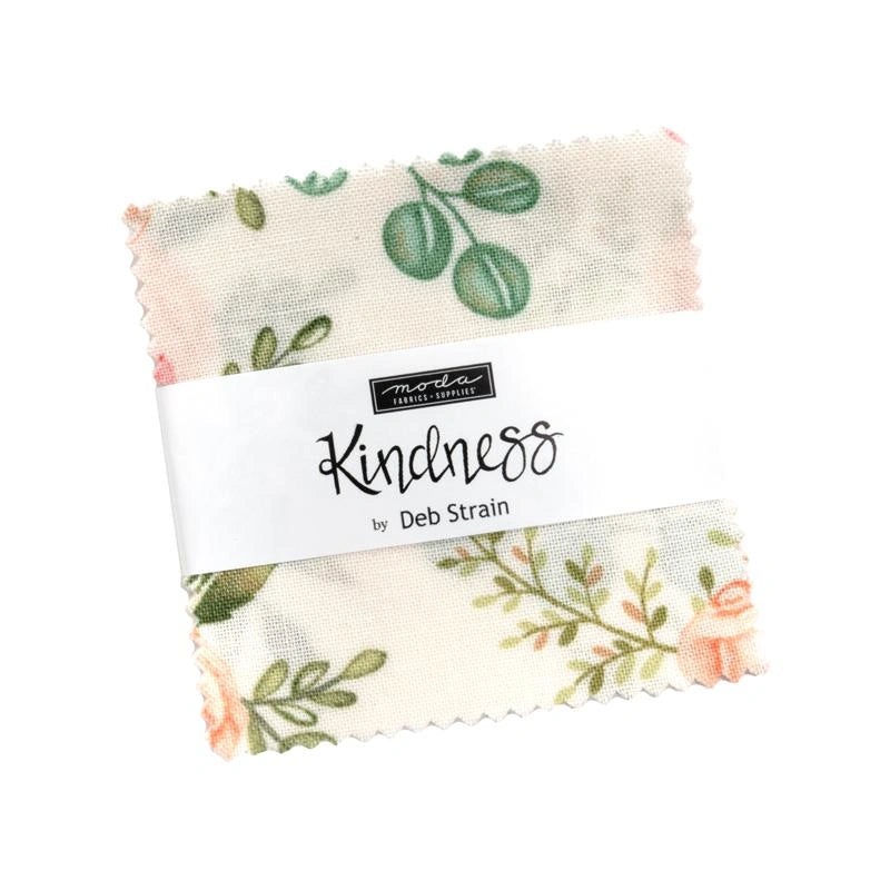 The Kindness Mini Charm by United Notions features a green and pink floral fabric square, wrapped with a white paper band.