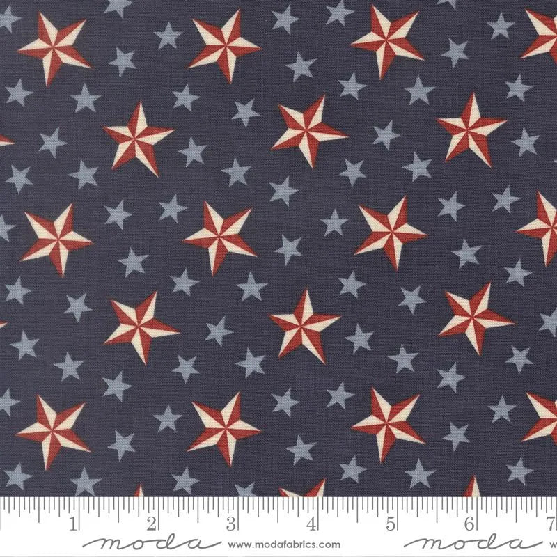 America 250 Years Loyalty Blue Tossed Stars Fabric by United Notions features large red and white striped stars with smaller light blue stars scattered on a dark patriotic background—ideal for commemorating America’s 250th anniversary.