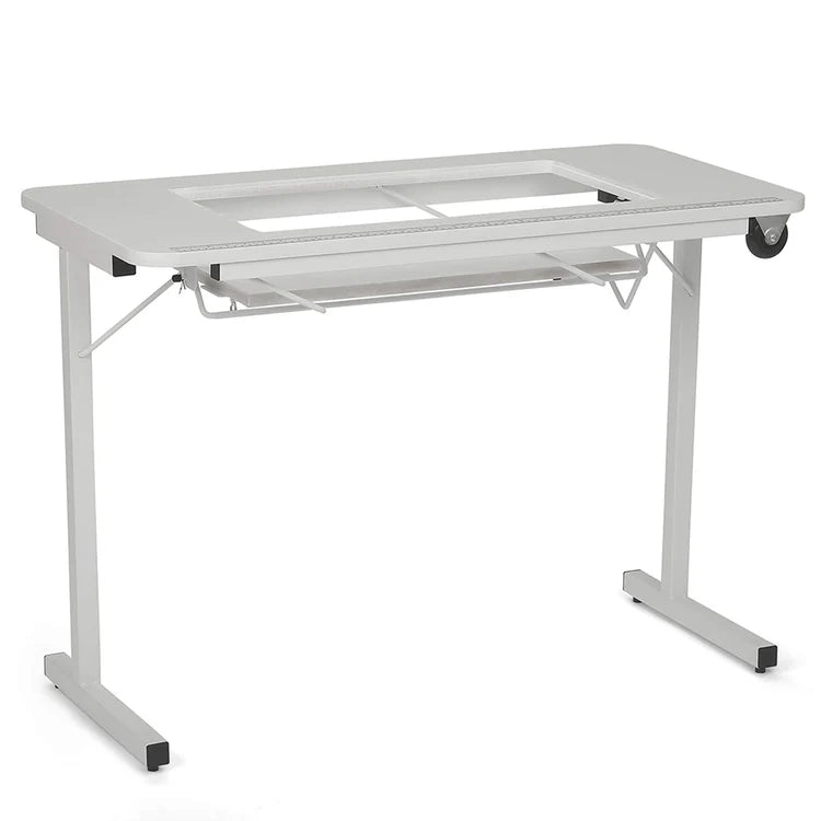 The Arrow Gidget II Sewing Table by Arrow Companies, LLC features a sleek white design, rectangular glass insert top, metal frame, pull-out keyboard tray, and wheeled leg for easy movement—ideal for creative workspaces.