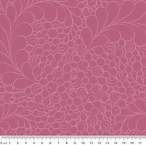 Happy Feather Pink Fabric Yardage from Benartex features overlapping circles and teardrop shapes for a textured, bubble-like look. The pink print is coordinated, with a white centimeter ruler shown at the bottom.
