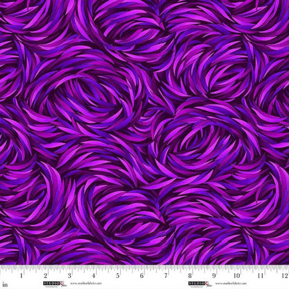 The QT Fabrics Tempest Pansy Swirl 108" Wide Quilt Backing Fabric features swirling purple and magenta brush strokes in a dynamic, textured pattern, plus a ruler with inches along the bottom edge—ideal for wide quilt backings.
