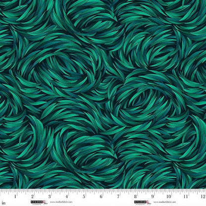 The QT Fabrics Tempest Jadite Swirl 108" Wide 3 Yard Quilt Fabric Back Pack features a seamless, textured green leaf pattern. A ruler at the bottom shows inches from 0 to 12 for scale.