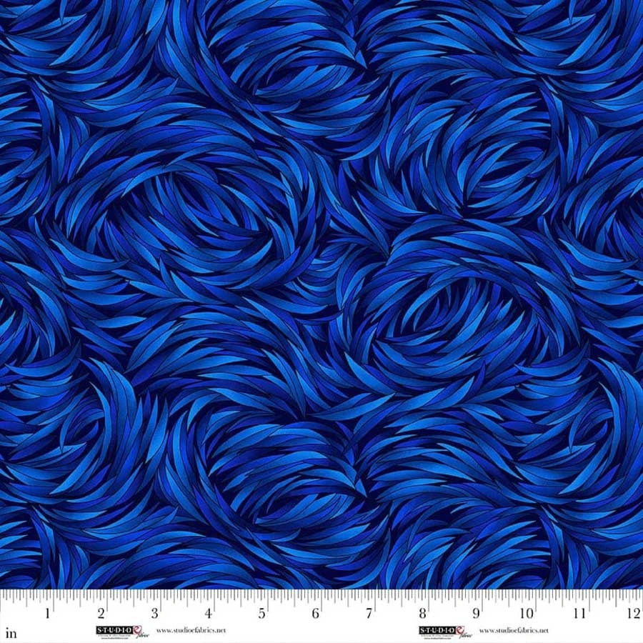 Blue and dark blue swirling curved lines, like flowing fur or feathers, feature a white inch ruler for scale—perfect as QT Fabrics Tempest Sapphire Swirl 108" Wide Quilt Backing Fabric.