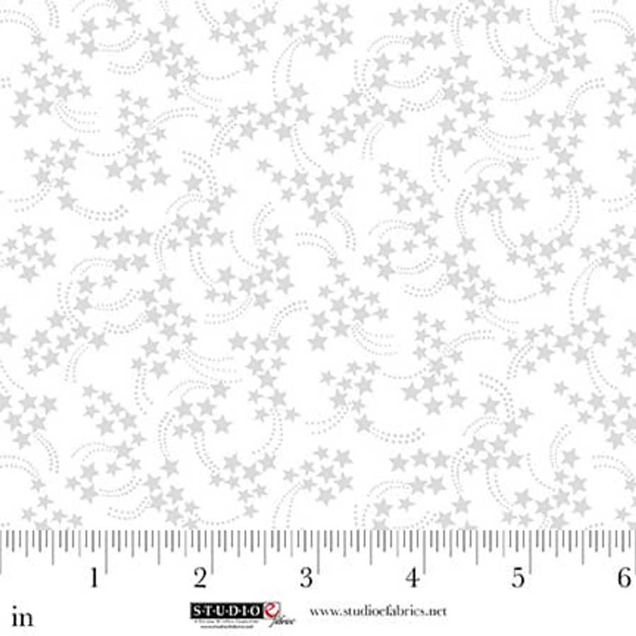 Best of Cream & Sugar White on White Shooting Stars Fabric Yardage by Jaftex - Studio E features small gray stars and dotted swirl lines. Ideal as a quilt blender, image shows a 0–6 inch ruler and Studio Fabrics branding below.