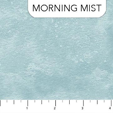 The image displays Northcott's Toscana Morning Mist Fabric Yardage, a textured light blue-gray quilt cotton, with a ruler at the bottom measuring up to 4 inches for scale.