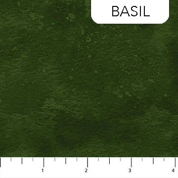 Toscana Basil Fabric Yardage by Northcott shown in dark green textured cotton, labeled "Basil" at the top right, with a white ruler along the bottom edge marked 1 to 4 inches.