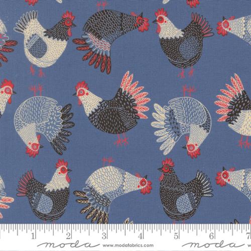 The Henhouse Tossed Chickens Novelty Cobalt Fabric Yardage by United Notions features tossed chickens in red, white, and gray on cobalt blue. Moda-branded ruler shown for scale—perfect for farmhouse quilting projects.