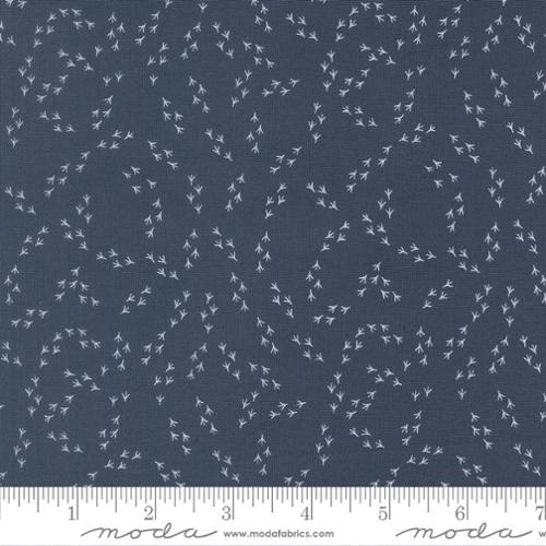 The Henhouse Chicken Feet Denim Fabric Yardage by United Notions features a dark gray farmhouse fabric with a scattered pattern of small, white, delicate leafy branches. A ruler at the bottom displays inch measurements and United Notions branding for scale.