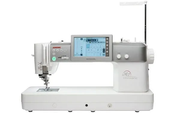 The JANOME Continental M7 Professional: PRE-LOVED by Quilted Joy is a professional sewing machine with a touchscreen, multiple control buttons, and the largest sewing area in its class, mainly white with gray accents and labeled “M7 Continental.”.