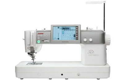 The JANOME Continental M7 Professional: PRE-LOVED by Quilted Joy is a professional sewing machine with a touchscreen, multiple control buttons, and the largest sewing area in its class, mainly white with gray accents and labeled “M7 Continental.”.