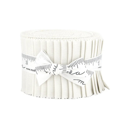 A rolled-up strip of pleated white United Notions fabric, secured with a measuring tape ribbon and tied in a bow, resembles the Bella Solids Feather Junior Jelly Roll.