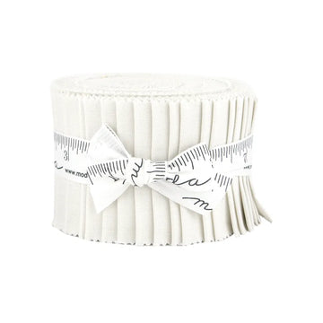 A rolled-up strip of pleated white United Notions fabric, secured with a measuring tape ribbon and tied in a bow, resembles the Bella Solids Feather Junior Jelly Roll.