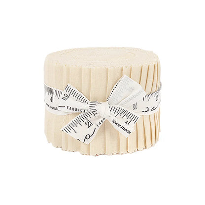 The Bella Solids Natural Junior Jelly Roll by United Notions features cream fabric strips rolled and tied with a measuring tape ribbon, displayed on a white background—ideal for quilting projects.