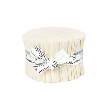 A United Notions Bella Solids Porcelain Junior Jelly Roll, featuring cream-hued strips stacked and tied with a white ribbon printed with a black measuring tape, is displayed against a white background.