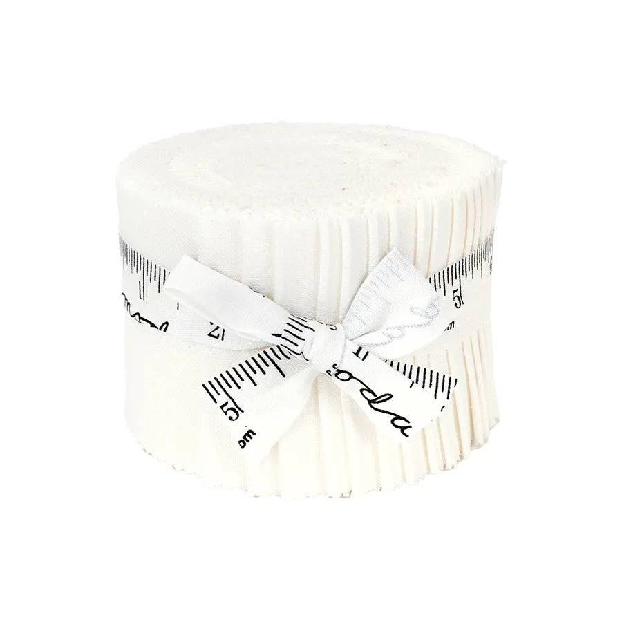 A rolled-up bundle of Bella Solids Off White Junior Jelly Roll fabric strips from United Notions, tied with a white ribbon printed with black measuring tape markings and cursive writing, displayed on a white background.