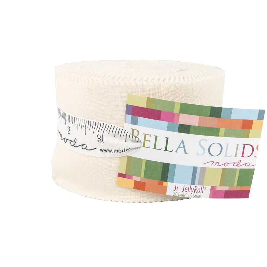 A Bella Solids Ivory Junior Jelly Roll from United Notions, rolled with a paper measuring tape and a colorful label card attached.