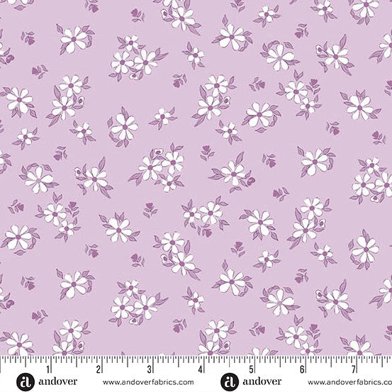 Andover's Color Me Whispered Periwinkle Treasure Blooms Fabric Yardage features light purple fabric with a repeating pattern of small white and purple flowers and leaves, shown with a ruler along the bottom edge for scale.