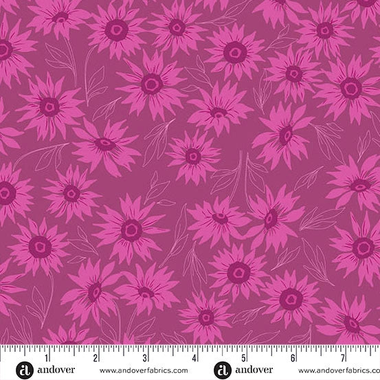 The Andover Color Me Whispered Magenta Marguerite Mist Fabric features a seamless pattern of pink sunflowers and fine line leaves on mauve, shown with an inch ruler for scale. Perfect for quilting projects.