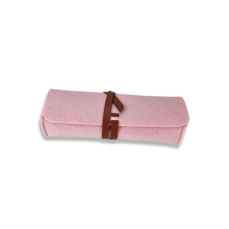 The Felt Pencil Notion Pouch D Rose is a soft pink felt pouch, rolled up and secured with a brown vegan leather closure, shown on a white background.
