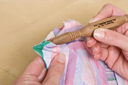 image of the Alex Andersons 4-in-1 Essential Sewing Tool pushing out corners in a handmade pillow