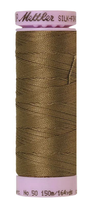 A spool of Mettler Cotton Silk Finish 50wt 150m Amygdala brown sewing thread with a pink plastic cap and base.