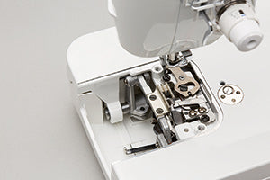 The automatic thread trimmer mechanism of the JUKI Haruka TL-18QVP, exposed below the needle plate.