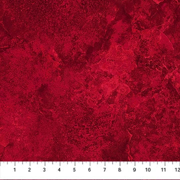 The Northcott Stonehenge Red Quartz Flannel 108" Wide 3 Yard Quilt Fabric Back Pack features a textured, marbled red 100% cotton flannel—ideal for quilt backing. A white ruler at the bottom shows inches from 1 to 12.
