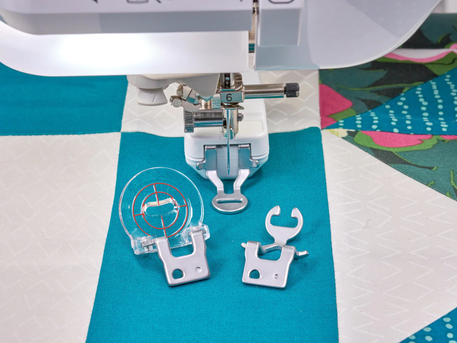 Close-up of the Baby Lock Anthem Sewing & Quilting Machine with FREE 60 Days of Online Classes, featuring its presser foot in use and three extra machine feet—an ideal bundle for precision stitching and quilting.