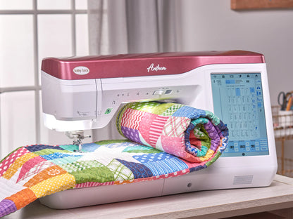 A Baby Lock Anthem Sewing & Quilting Machine with FREE 60 Days of Online Classes, featuring a red and white exterior and digital StitchSync Regulation display, stitches a colorful patchwork quilt as sunlight spills through a window.