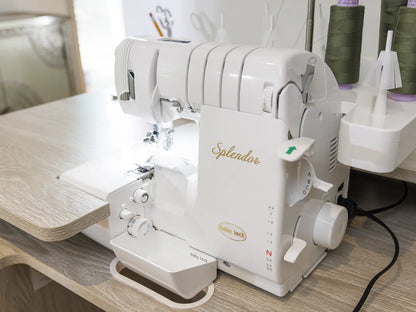 A Baby Lock Splendor 8-Thread Combination Serger with ExtraordinAir™ Threading sits on a wooden table amid green thread and sewing tools—ideal for any sewer, plus comes with FREE 60 days of online classes.