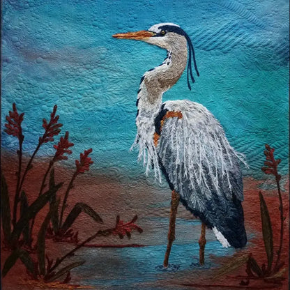 Experience the artistry of Bethanne Nemesh at the Yarn Couching Trunk Show on Friday, March 13th, 2026, featuring her exquisite textile artworks like a heron in vibrant natural surroundings crafted with stunning yarn couching techniques.