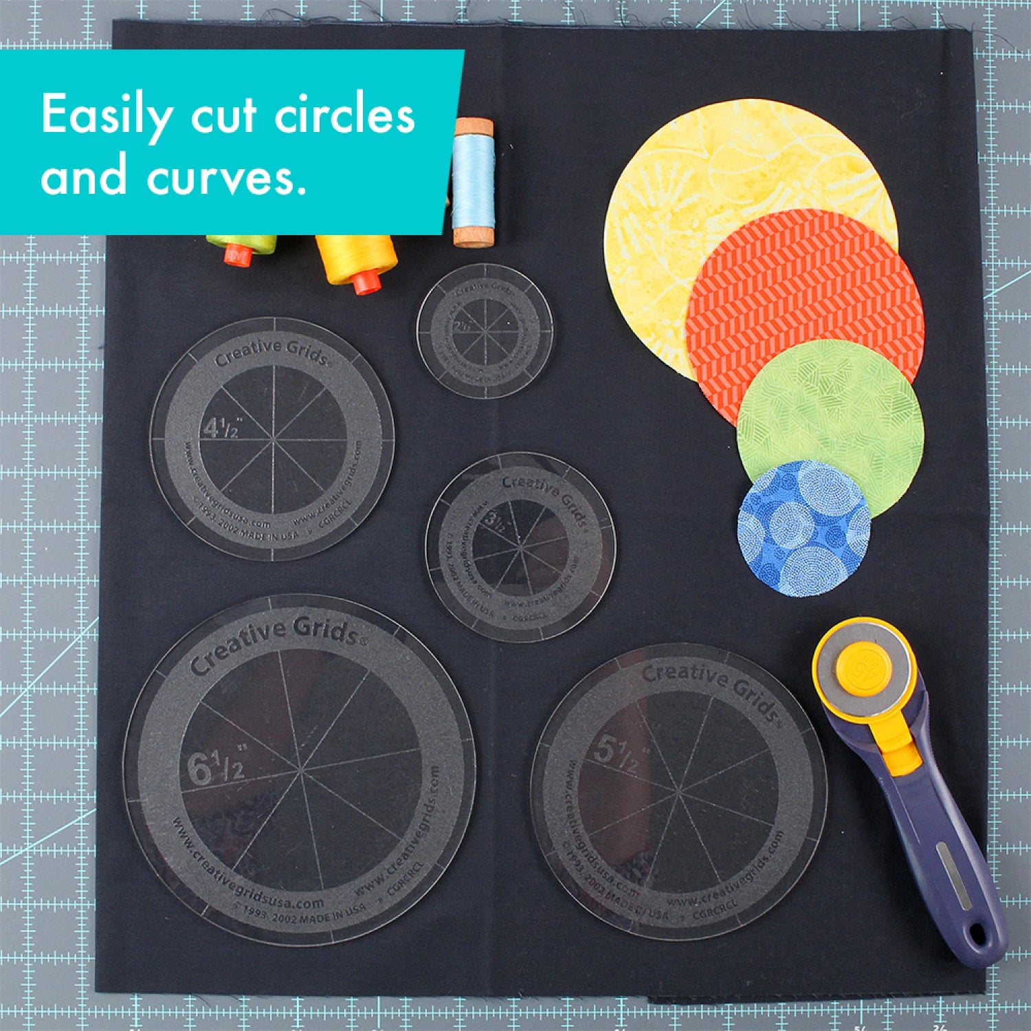 The Creative Grids Quilt Ruler Circles Set of 5 by Checker Distributor, plus colorful fabric circles, thread spools, and a rotary cutter, are arranged on a black mat with text: Easily cut circles—ideal for Japanese Folded Patchwork.