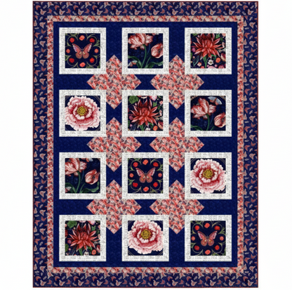 The Cameo Appearance Quilt Kit by Quilted Joy features a dark blue background with squares of pink and red florals and butterflies, inspired by bold floral quilt styles. The border showcases a repeating butterfly design.