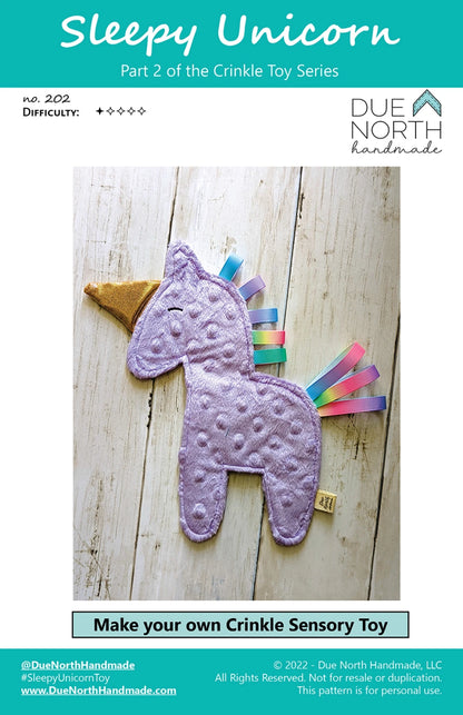 The Sleepy Unicorn Crinkle Toy Pattern by Checker Distributor lets you sew a handmade purple unicorn with a gold horn and ribbon mane. Includes beginner-friendly instructions and a printed paper pattern. Perfect for sensory play projects.
