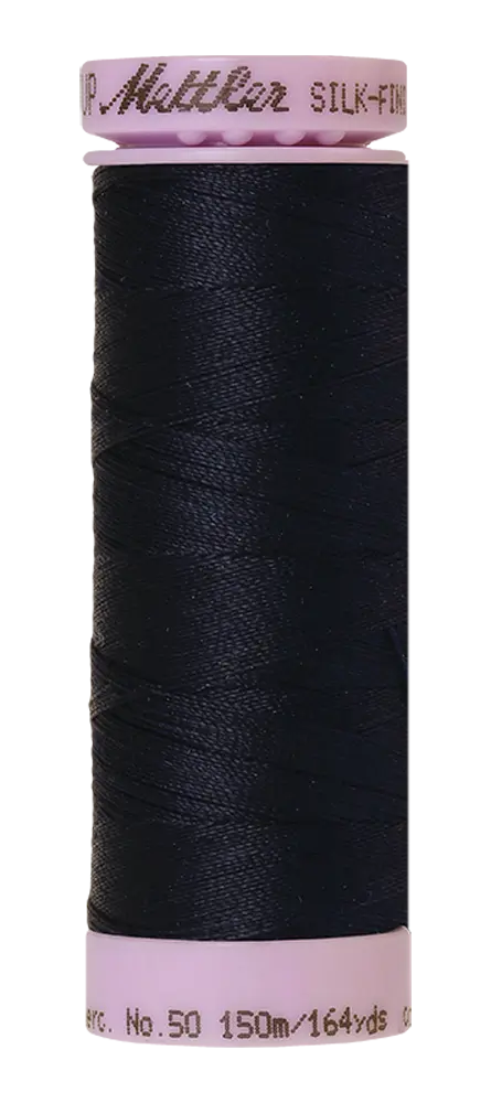 A spool of dark blue Mettler Cotton Silk Finish 50wt sewing thread contains 150 meters (164 yards) of premium cotton quilting thread.