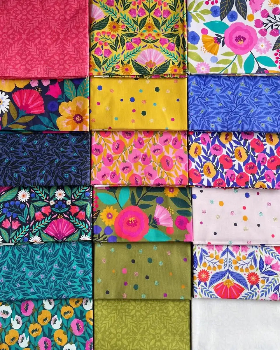 A vibrant grid of quilting fabric squares from the Dayspring Fat Quarter Bundle by Windham Fabrics, featuring floral, leaf, and polka dot patterns in lively pinks, yellows, blues, greens, and whites—ideal for your next quilting project.