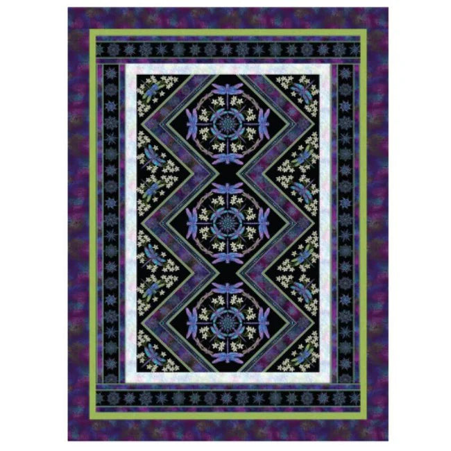 The Dragonflies Take a Spin Quilt Kit by Quilted Joy features a zigzag central pattern with blue dragonflies, floral motifs, and white flowers on black, bordered by blues, greens, and purples—crafted with premium Benartex fabric.
