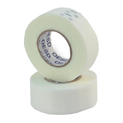 The image shows two rolls of OESD Expert Embroidery Tape Tear Away (3/4in x 10yds); one roll stands upright, the other leans against it. “OESD” is printed inside, ideal for temporary placement in in-the-hoop embroidery projects.