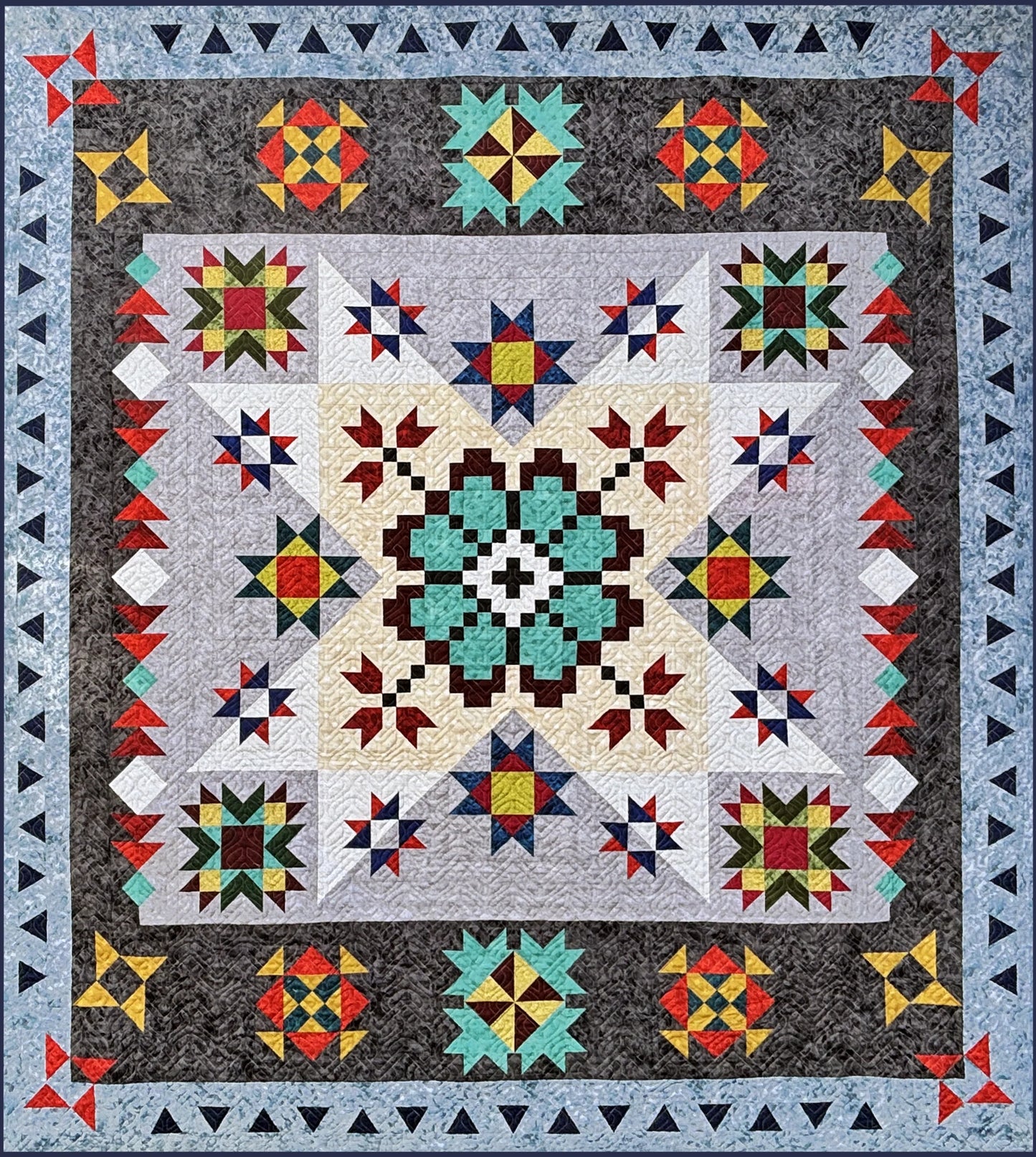 The Echoes of Iceland Block of the Month Kick Off by Quilted Joy features a vibrant patchwork quilt with intricate geometric patterns, a bold teal and black central motif, star shapes, and angular blue-gray borders.