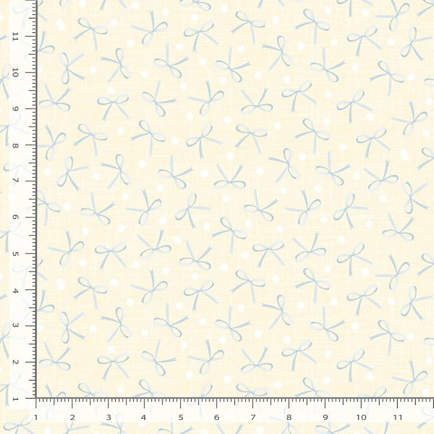 The Quilted Joy Friendship Cows Backing Kit Til the Cows Come Home Vanilla Bows features pale yellow fabric with light blue hand-drawn bows and white polka dots, shown with rulers for scale—perfect as a quilt backing or for your kit.
