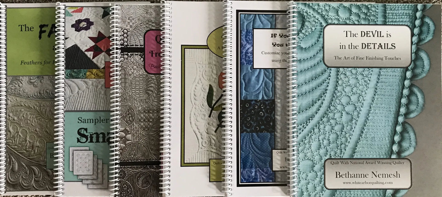 The Bethanne Nemesh Complete Book Collection by White Arbor Quilting includes five spiral-bound quilting workbooks, each featuring unique cover designs and expert tips for mastering precision quilting rulers.