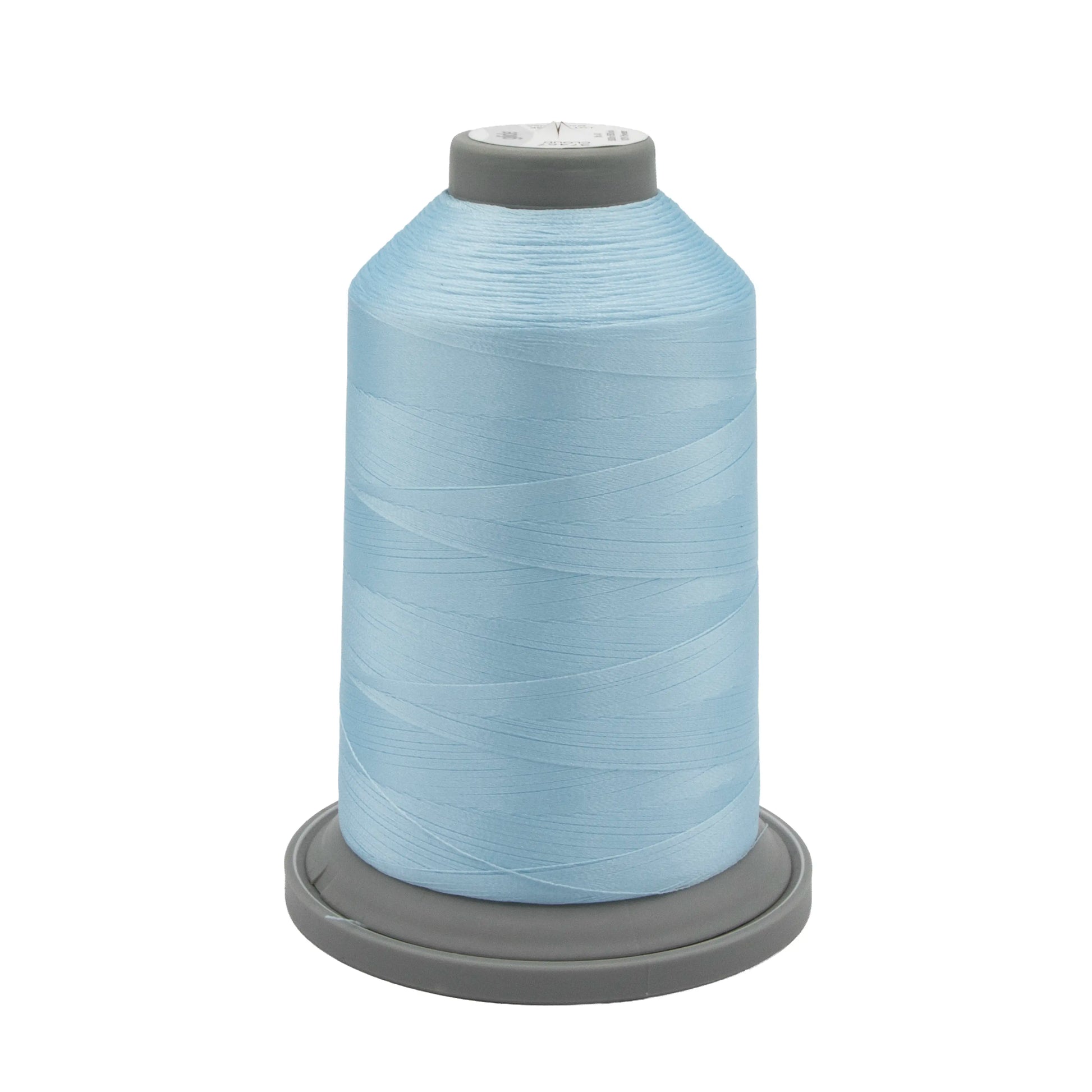 A large spool of Hab+Dash Glide Thread Cloud 37457 polyester thread in light blue, on a gray plastic base—perfect for machine quilting—displayed against a white background.
