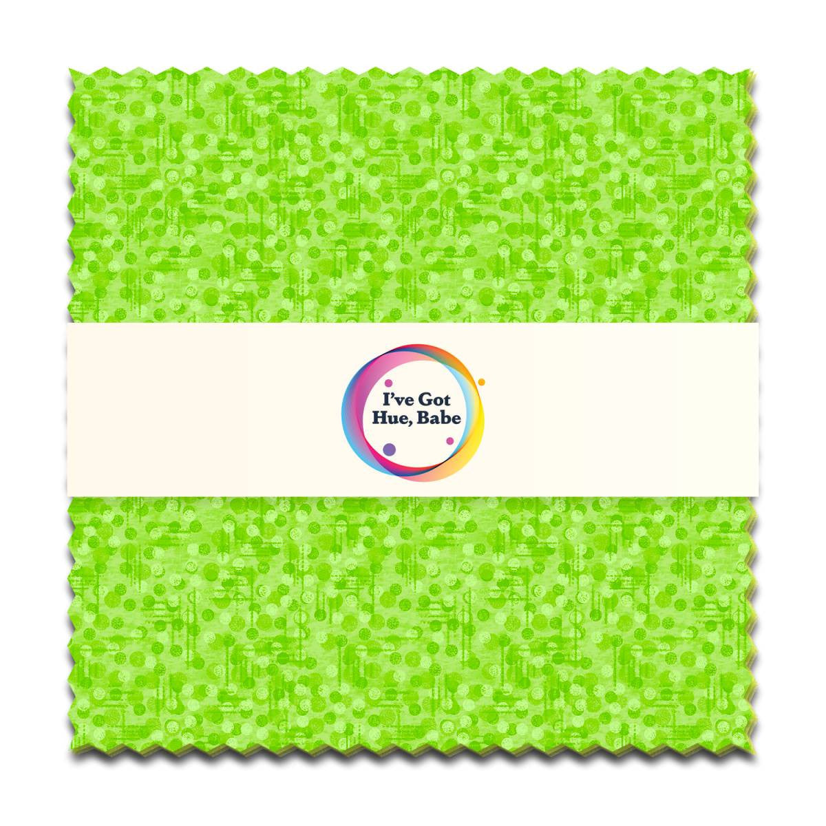 A green 5" fabric square from Jaftex - Henry Glass Fabrics' "I've Got Hue, Babe Green Giant" pack features a subtle circular pattern, pinked edges, and a white band with the colorful logo—ideal for precut quilt projects.