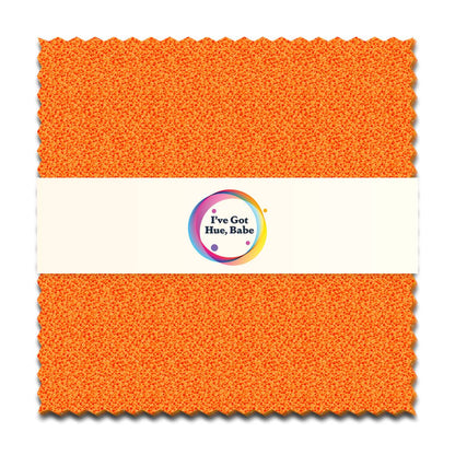 A square orange textured precut quilt fabric swatch with zigzag edges. A white band at the center displays a colorful circular logo and the text I've Got Hue, Babe Marmalade 5" Squares by Jaftex - Henry Glass Fabrics.