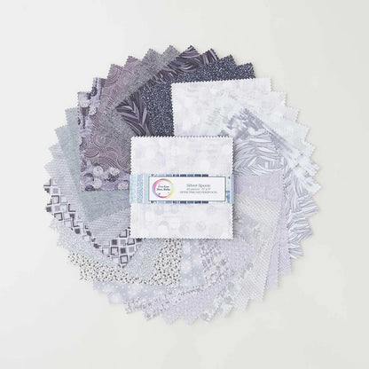 A circle of grey, silver, and white patterned fabric swatches surrounds a neatly stacked charm pack of Jaftex - Henry Glass Fabrics' I've Got Hue, Babe Silver Spoon 5" Squares, tied with a ribbon in the center.