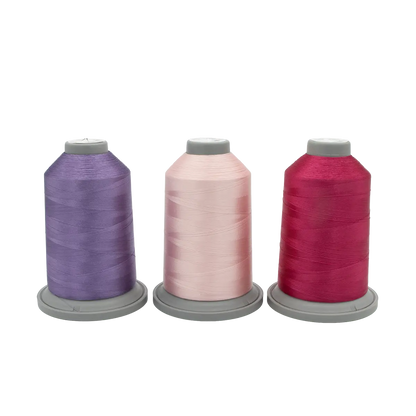 Three spools of Hab+Dash by Fil Tec thread in purple, light pink, and dark pink are arranged side by side—perfect for your next Hyacinth Haven Glide Thread of the Month Bundle.