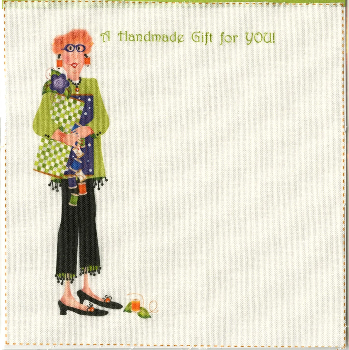 Illustration of a smiling person with red hair, glasses, and a green top holding patchwork fabric. Surrounding are sewing items and Checker Distributor’s Quilting Hope Quilt Label 2 pack. “A Handmade Gift for YOU!” reads above. Blank space completes the image.