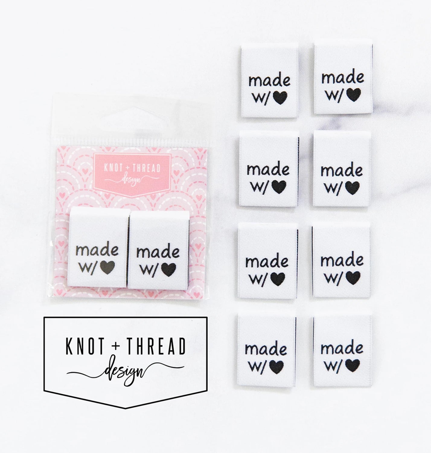 Eight white “Made With ♥” sew-in labels from Checker Distributor are arranged in a grid. A package with two labels and pink backing is at the top left. "KNOT + THREAD design" appears below. Ideal for handmade creations.