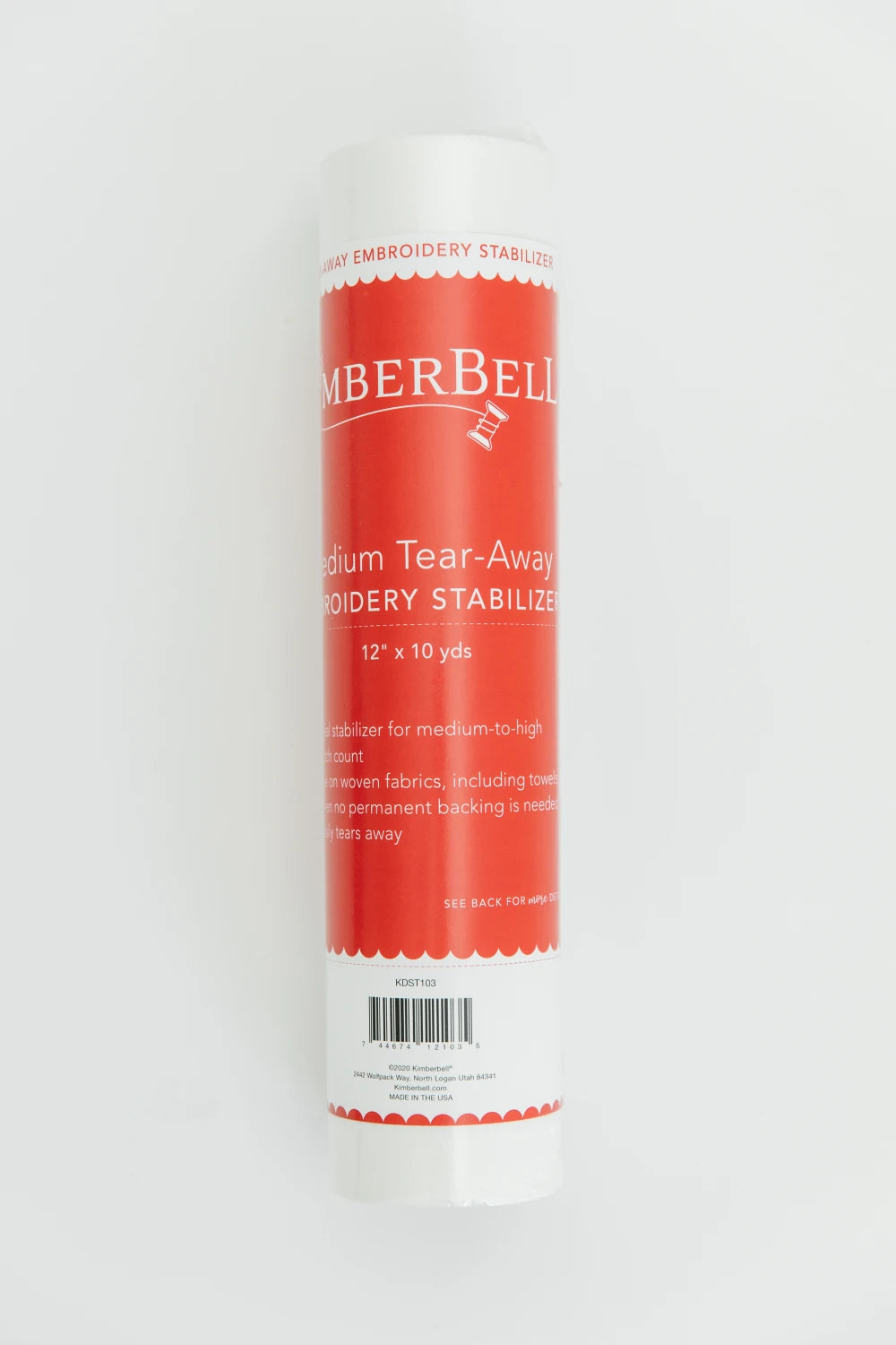 A roll of Kimberbell Medium Tear-Away 12in x 10yd by Checker Distributor, featuring a red and white label, stands upright against a plain white background.