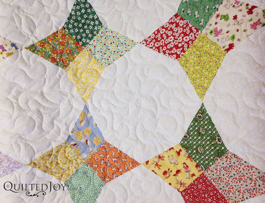 Scrappy star quilt block with swirling longarm quilting